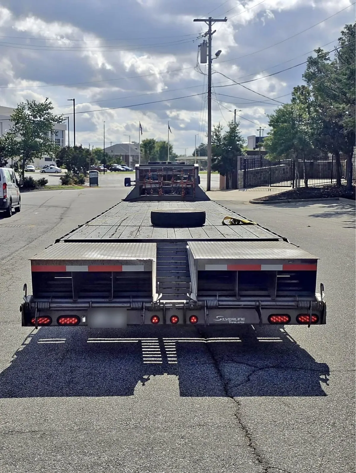 Rear of Silverline deckover trailer showing dovetail and flip-up ramps